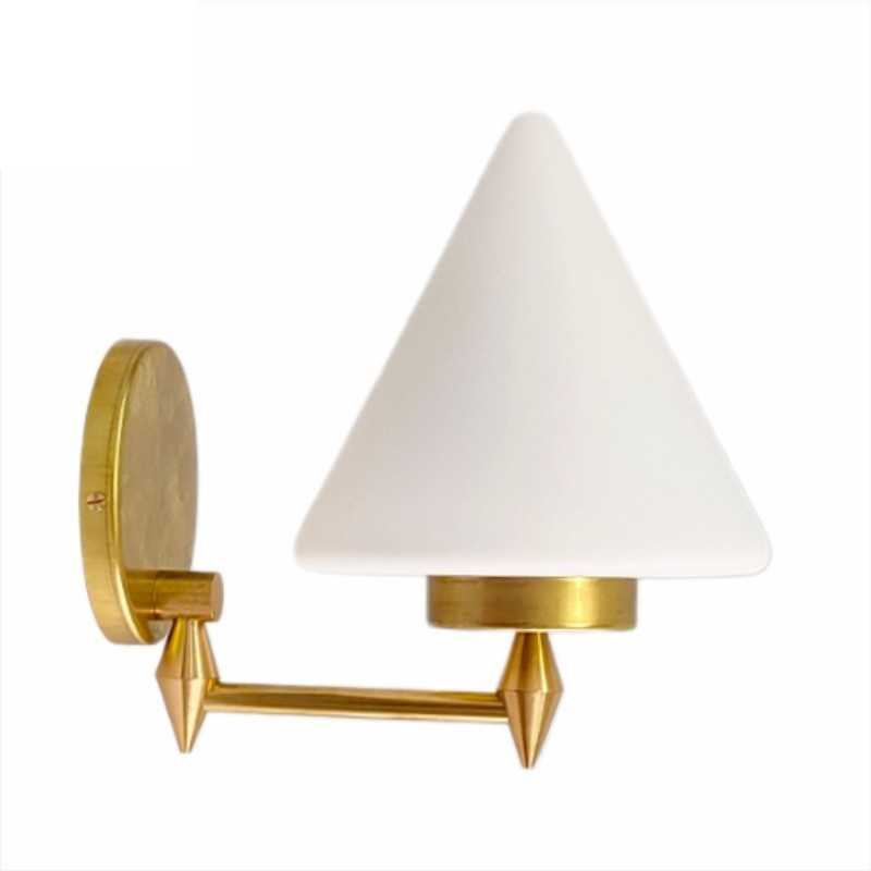 Brass wall light with matte conical glass shade