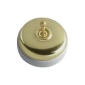 Porcelain surface modular switch in golden brass.